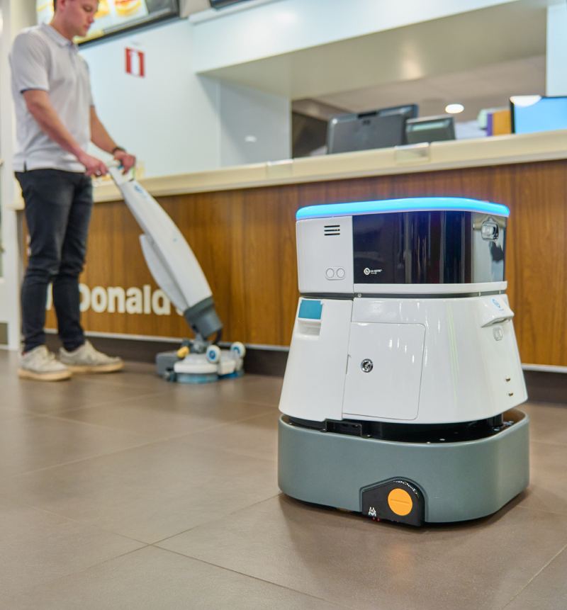 Co-botic 45 in a restaurant, working together with the human cleaner